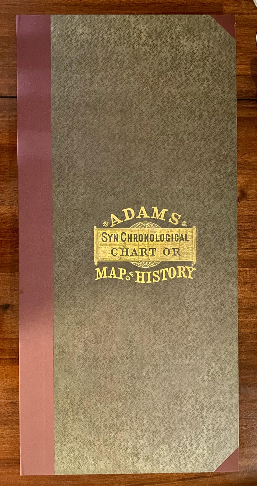 The cloth cover of the Adams History Chart with its gilt title label